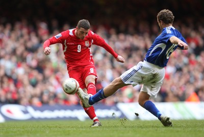 28.03.09 - Wales v Finland, FIFA World Cup 2010 Qualifying Group 4 -  Wales' Jason Koumas fires a shot at goal as Finland's Jonatan Johansson closes in 