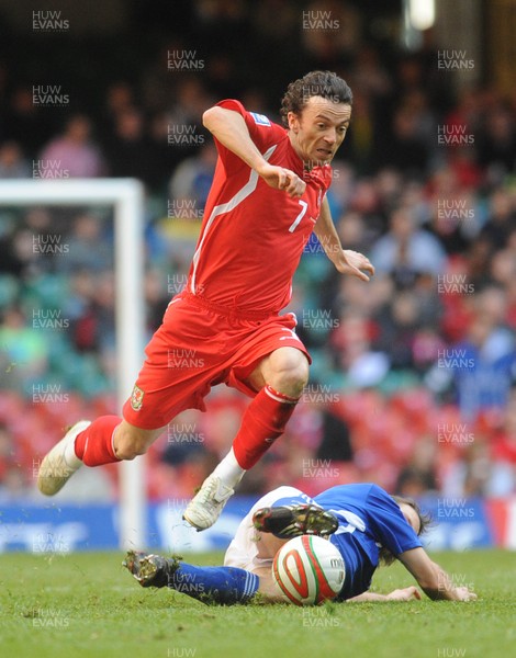 28.03.09 - Wales v Finland, FIFA World Cup 2010 Qualifying Group 4 -  Wales' Simon Davies is brought down by a tackle from Finland's Markus Heikkinen 