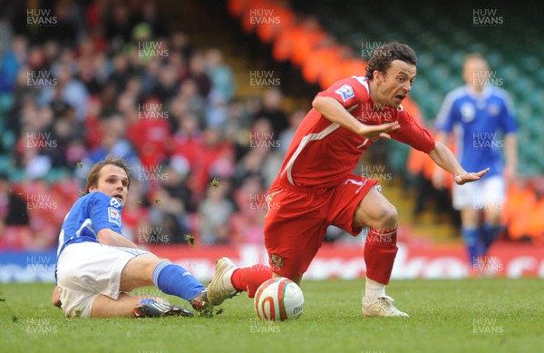 28.03.09 - Wales v Finland, FIFA World Cup 2010 Qualifying Group 4 -  Wales' Simon Davies is brought down by a tackle from Finland's Markus Heikkinen 