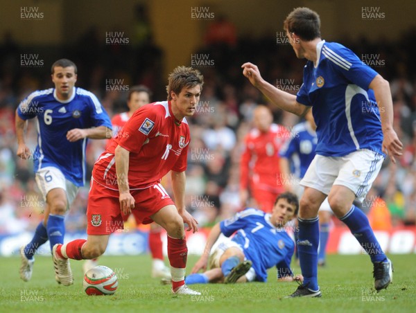 28.03.09 - Wales v Finland, FIFA World Cup 2010 Qualifying Group 4 -  Wales' Aaron Ramsey tries to get past Finland's Toni Kallio as Aleksei Eremenko (L) and  Roman Eremenko look on 