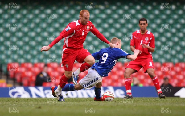 28.03.09 - Wales v Finland, FIFA World Cup 2010 Qualifying Group 4 -  Wales' James Collins tangles with Finland's Mikael Forssell   