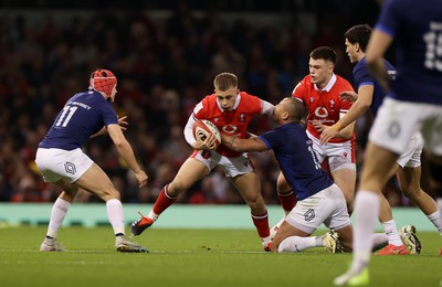 100324 - Wales v France - Guinness 6 Nations Championship - Cameron Winnett of Wales is tackled by Gael Fickou of France 