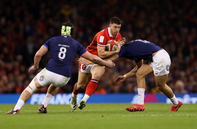 100324 - Wales v France - Guinness 6 Nations Championship - Owen Watkin of Wales is tackled by Gregory Alldritt and Nicolas Depoortere of France 