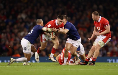 100324 - Wales v France - Guinness 6 Nations Championship - Joe Roberts of Wales is tackled by Gael Fickou and Thomas Ramos of France 