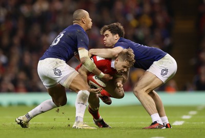 100324 - Wales v France - Guinness 6 Nations Championship - Sam Costelow of Wales is tackled by Gael Fickou and Nicolas Depoortere of France 