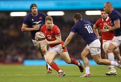 100324 - Wales v France - Guinness 6 Nations Championship - Sam Costelow of Wales is challenged by Thomas Ramos of France 