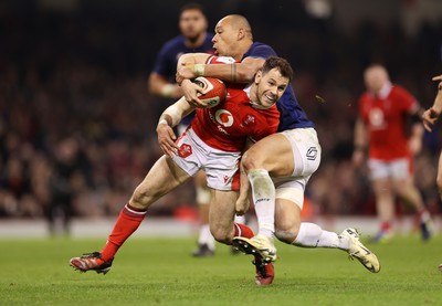 100324 - Wales v France - Guinness 6 Nations Championship - Tomos Williams of Wales is tackled by Gael Fickou of France 