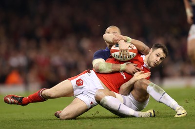 100324 - Wales v France - Guinness 6 Nations Championship - Tomos Williams of Wales is tackled by Gael Fickou of France 