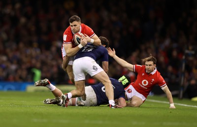 100324 - Wales v France - Guinness 6 Nations Championship - Mason Grady of Wales is tackled by Damian Penaud of France 