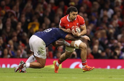 100324 - Wales v France - Guinness 6 Nations Championship - Mackenzie Martin of Wales is tackled by Romain Taofifenua of France 