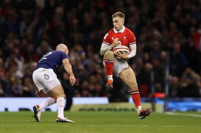 100324 - Wales v France - Guinness 6 Nations Championship - Cameron Winnett of Wales is challenged by Maxime Lucu of France 