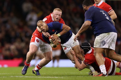 100324 - Wales v France - Guinness 6 Nations Championship - Gael Fickou of France is tackled by Keiron Assiratti of Wales 