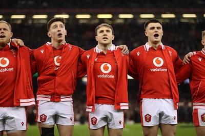 100324 - Wales v France - Guinness 6 Nations Championship - Josh Adams, Ioan Lloyd and Joe Roberts of Wales sing the anthem