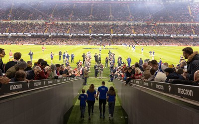 100324 - Wales v France Guinness 6 Nations - Craig Maxwell walks the match ball out at the Principality Stadium after completing his around Wales Walk for Cancer Research