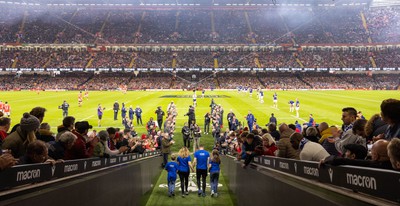 100324 - Wales v France Guinness 6 Nations - Craig Maxwell walks the match ball out at the Principality Stadium after completing his around Wales Walk for Cancer Research