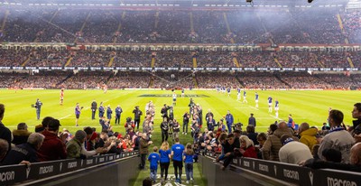 100324 - Wales v France Guinness 6 Nations - Craig Maxwell walks the match ball out at the Principality Stadium after completing his around Wales Walk for Cancer Research