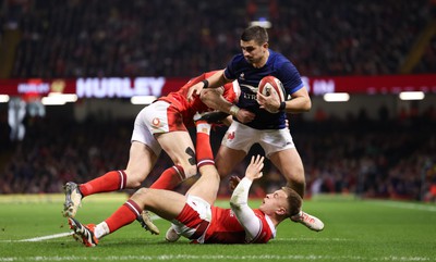 100324 - Wales v France Guinness 6 Nations - Thomas Ramos of France is tackled by Josh Adams of Wales and Cameron Winnett of Wales