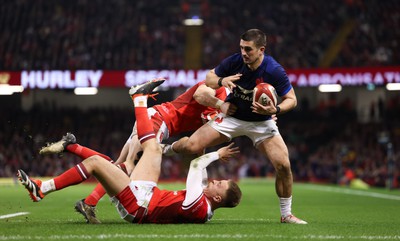 100324 - Wales v France Guinness 6 Nations - Thomas Ramos of France is tackled by Josh Adams of Wales and Cameron Winnett of Wales