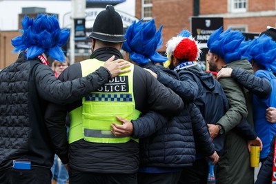 100324 - Wales v France - Guinness Six Nations - A police officer has his photo taken with France fans before the match