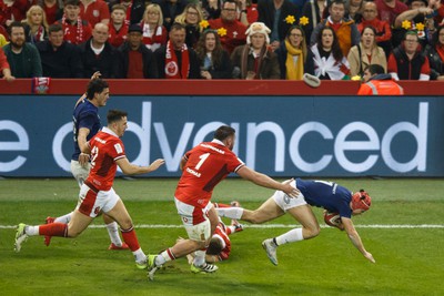 100324 - Wales v France - Guinness Six Nations - Louis Bielle Biarrey of France is tackled by Sam Costelow of Wales