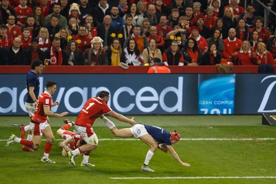 100324 - Wales v France - Guinness Six Nations - Louis Bielle Biarrey of France is tackled by Sam Costelow of Wales