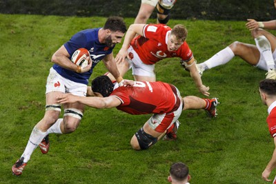 100324 - Wales v France - Guinness Six Nations - Charles Ollivon of France is tackled by Dafydd Jenkins of Wales