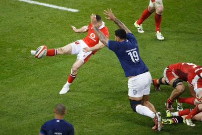 100324 - Wales v France - Guinness Six Nations - Romain Taofifenua of France charges down the kick of Gareth Davies of Wales before going on to score a try