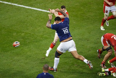 100324 - Wales v France - Guinness Six Nations - Romain Taofifenua of France charges down the kick of Gareth Davies of Wales before going on to score a try