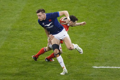 100324 - Wales v France - Guinness Six Nations - Leo Barre of France escapes from the tackle of Tomos Williams of Wales