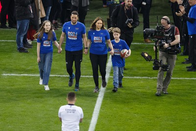 100324 - Wales v France - Guinness Six Nations - Craig Maxwell and family deliver the match ball onto the pitch