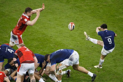 100324 - Wales v France - Guinness Six Nations - Nolann Le Garrec of France kicks the ball under pressure from Will Rowlands of Wales