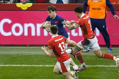 100324 - Wales v France - Guinness Six Nations - Damian Penaud of France tries to get past Rio Dyer of Wales