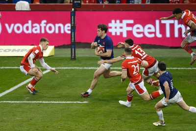 100324 - Wales v France - Guinness Six Nations - Damian Penaud of France takes on Cameron Winnett of Wales