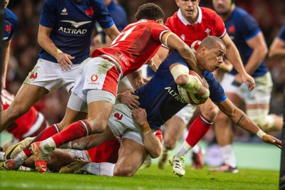 100324 - Wales v France - Guinness Six Nations - Gael Fickou of France is tackled by Rio Dyer of Wales