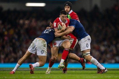 100324 - Wales v France - Guinness Six Nations - Owen Watkin of Wales is tackled by Nicolas Depoortere of France and Francois Cros of France