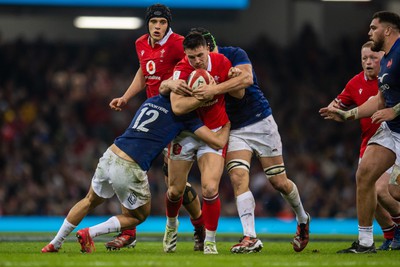 100324 - Wales v France - Guinness Six Nations - Owen Watkin of Wales is tackled by Nicolas Depoortere of France and Francois Cros of France