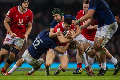 100324 - Wales v France - Guinness Six Nations - Owen Watkin of Wales is tackled by Nicolas Depoortere of France and Francois Cros of France