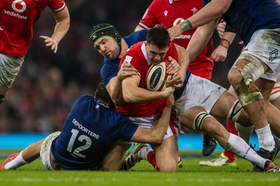 100324 - Wales v France - Guinness Six Nations - Owen Watkin of Wales is tackled by Nicolas Depoortere of France and Francois Cros of France