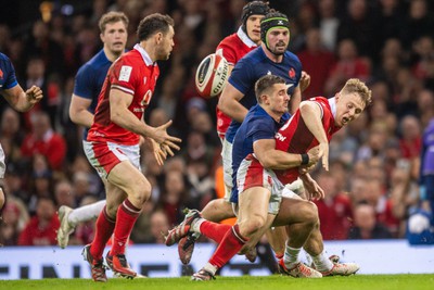 100324 - Wales v France - Guinness Six Nations - Sam Costelow of Wales is tackled by Thomas Ramos of France