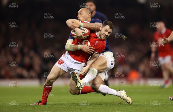 100324 - Wales v France - Guinness 6 Nations Championship - Tomos Williams of Wales is tackled by Gael Fickou of France 