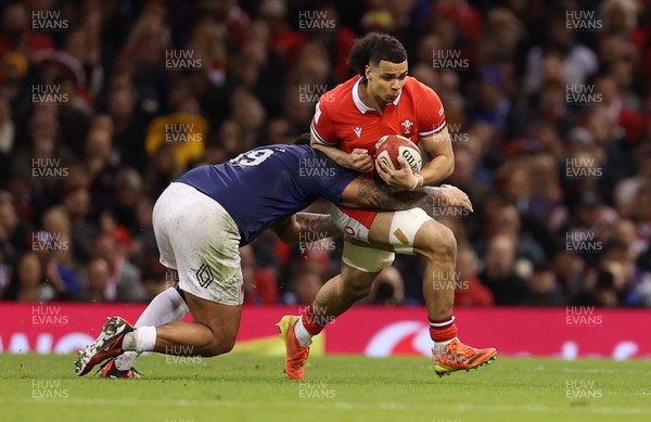 100324 - Wales v France - Guinness 6 Nations Championship - Mackenzie Martin of Wales is tackled by Romain Taofifenua of France 