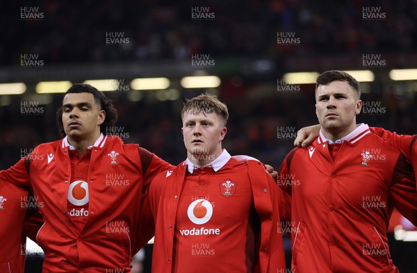 100324 - Wales v France - Guinness 6 Nations Championship - Mackenzie Martin, Evan Lloyd and Mason Grady of Wales sing the anthem