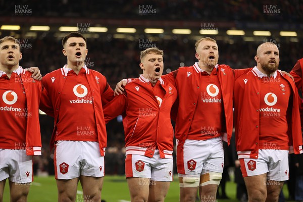 100324 - Wales v France - Guinness 6 Nations Championship - Joe Roberts, Sam Costelow, Tommy Reffell and Dillon Lewis of Wales sing the anthem