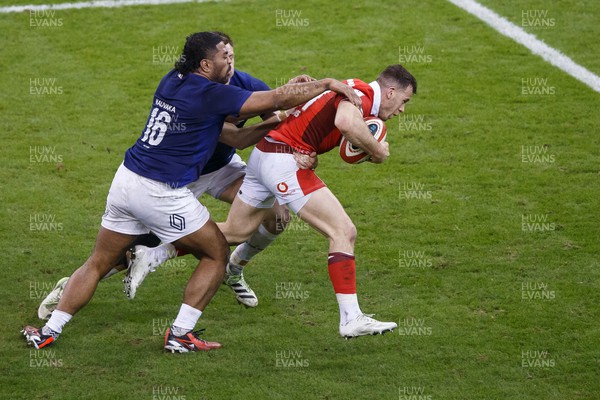 100324 - Wales v France - Guinness Six Nations - Gareth Davies of Wales is tackled by Peato Mauvaka and Gregory Alldritt of France