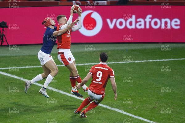 100324 - Wales v France - Guinness Six Nations - Cameron Winnett of Wales competes with Louis Bielle Biarrey of France for the ball near the Wales try line
