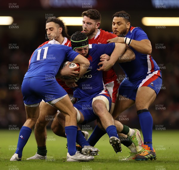 110322 - Wales v France - Guinness Six Nations - Gregory Alldritt of France is tackled by Josh Navidi and Alex Cuthbert of Wales