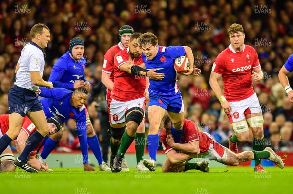 110322 - Wales v France - Guinness Six Nations - Antoine Dupont of France is tackled by Taulupe Faletau of Wales 