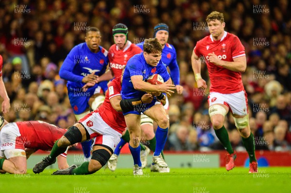 110322 - Wales v France - Guinness Six Nations - Antoine Dupont of France is tackled by Taulupe Faletau of Wales 