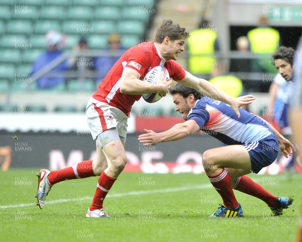 120513 - Wales v France - Bowl Final - HSBC Sevens World Series - Chris Knight of Wales, left, is tackled by Thibaut Zambelli of France