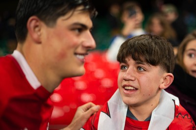 150226 - Wales v France - Guinness Six Nations - Fans take selfies with Louis Rees-Zammit after the game   